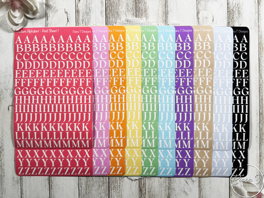 Sheet of alphabet stickers with various colors on a wooden surface